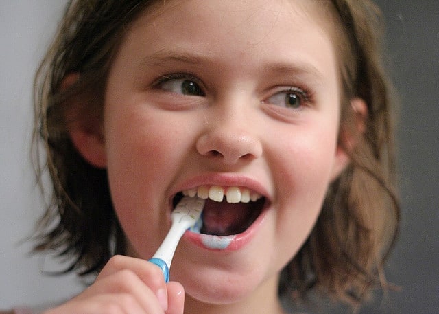 Child brushing teeth image
